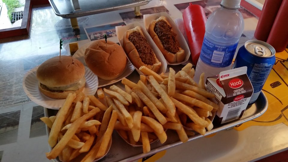 Hot dogs on a paper tray at a stand.